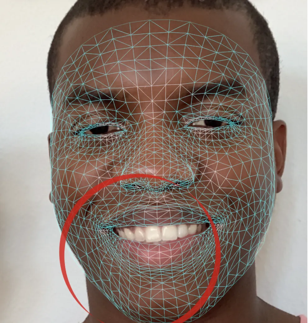 Face with a 3D tracking mesh overlay