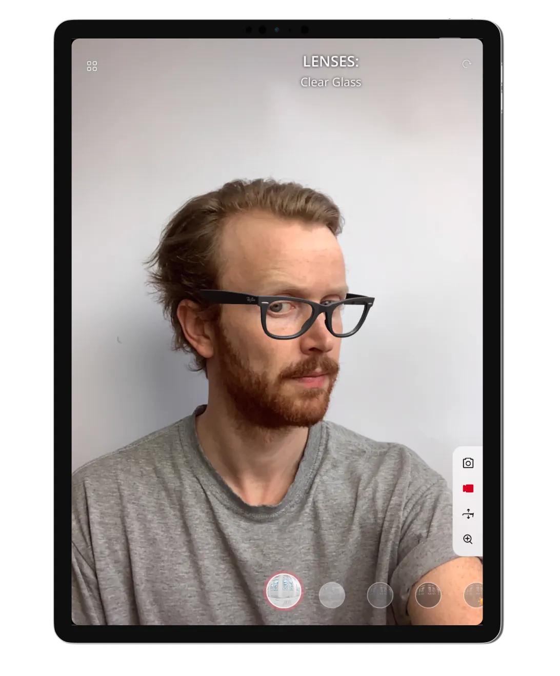 Man trying on glasses in an app on a tablet