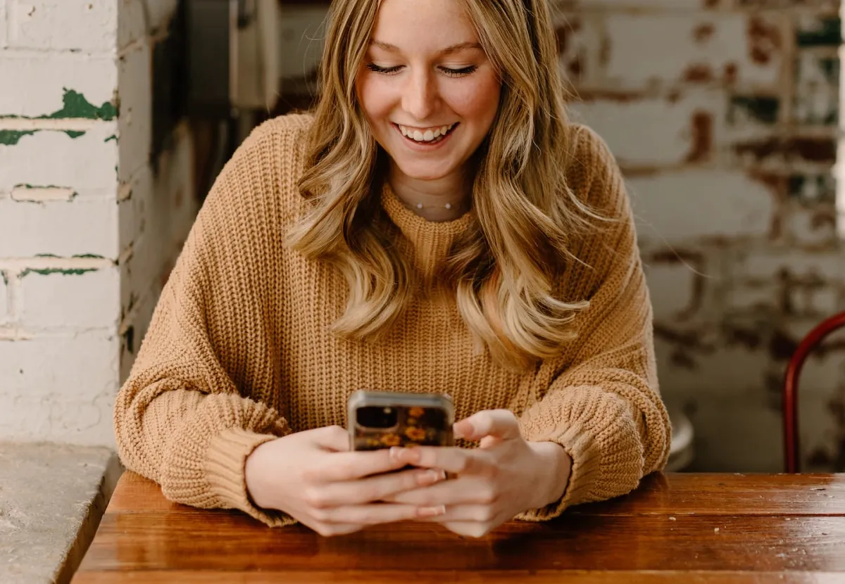 Woman using her smartphone at a table